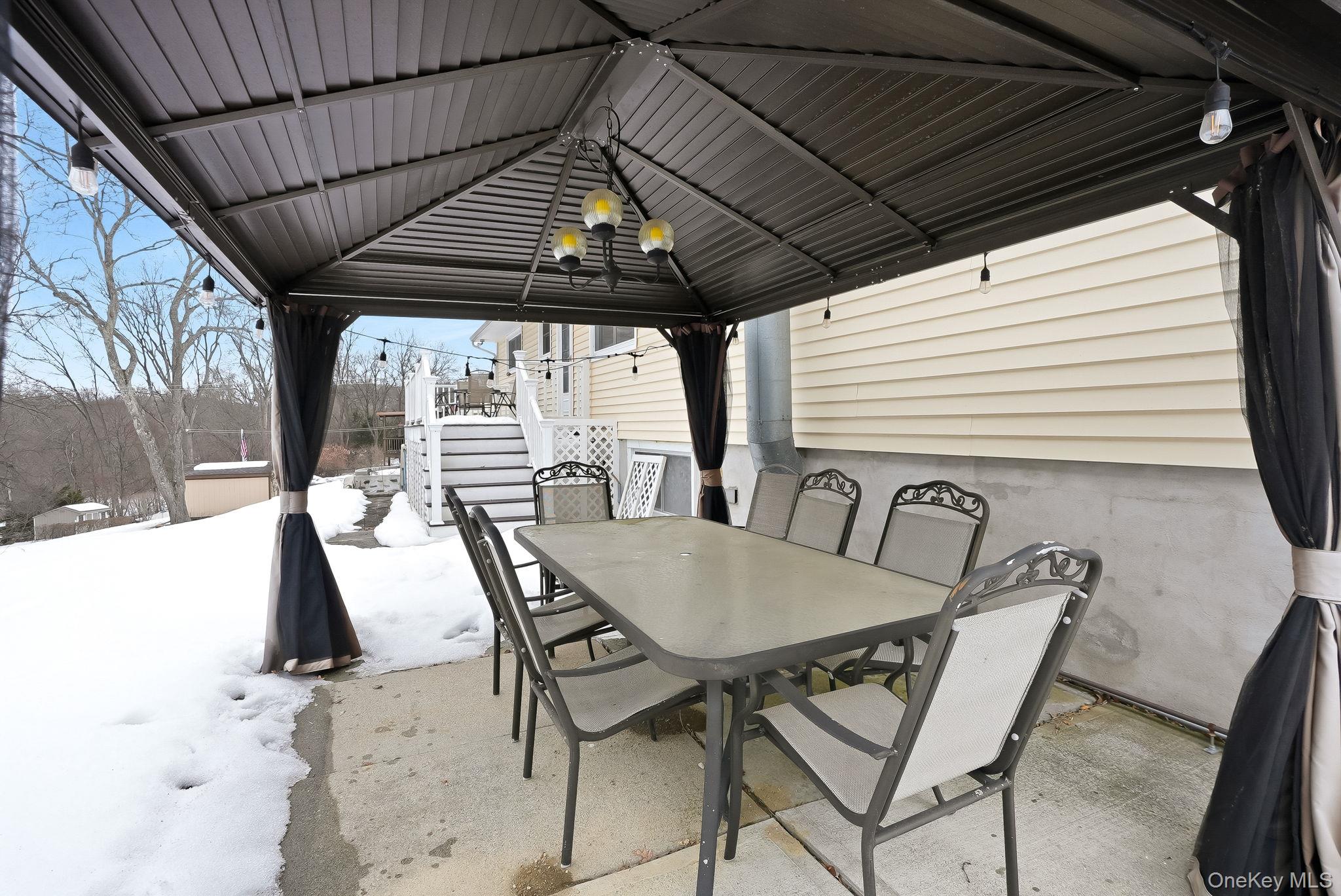 12 Lakeview Road Carmel, NY 10512 - Photo 22 of 31 a view of a patio with table and chairs with wooden floor and fence