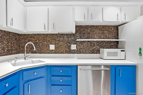 a kitchen with stainless steel appliances granite countertop a sink and a microwave