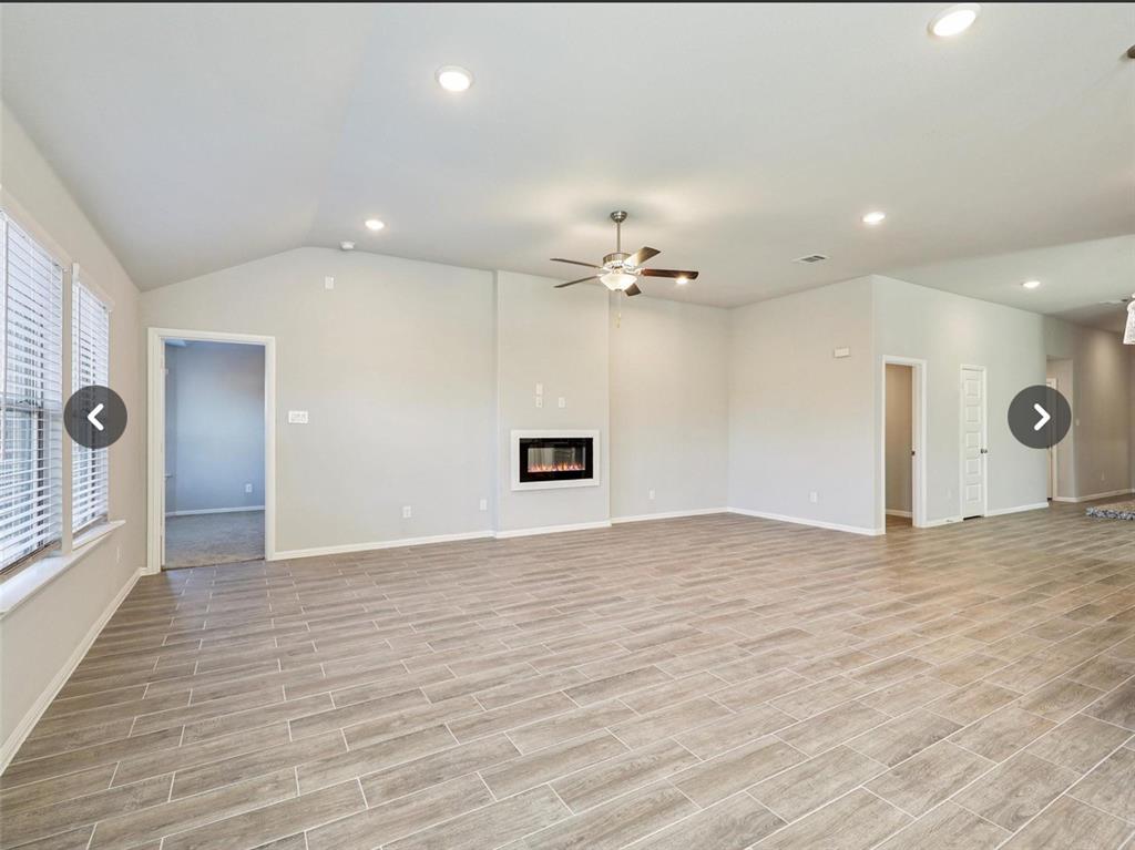 14219 Aberavon Drive Pilot Point, TX 76258 - Photo 12 of 25 a view of an empty room with wooden floor and a window