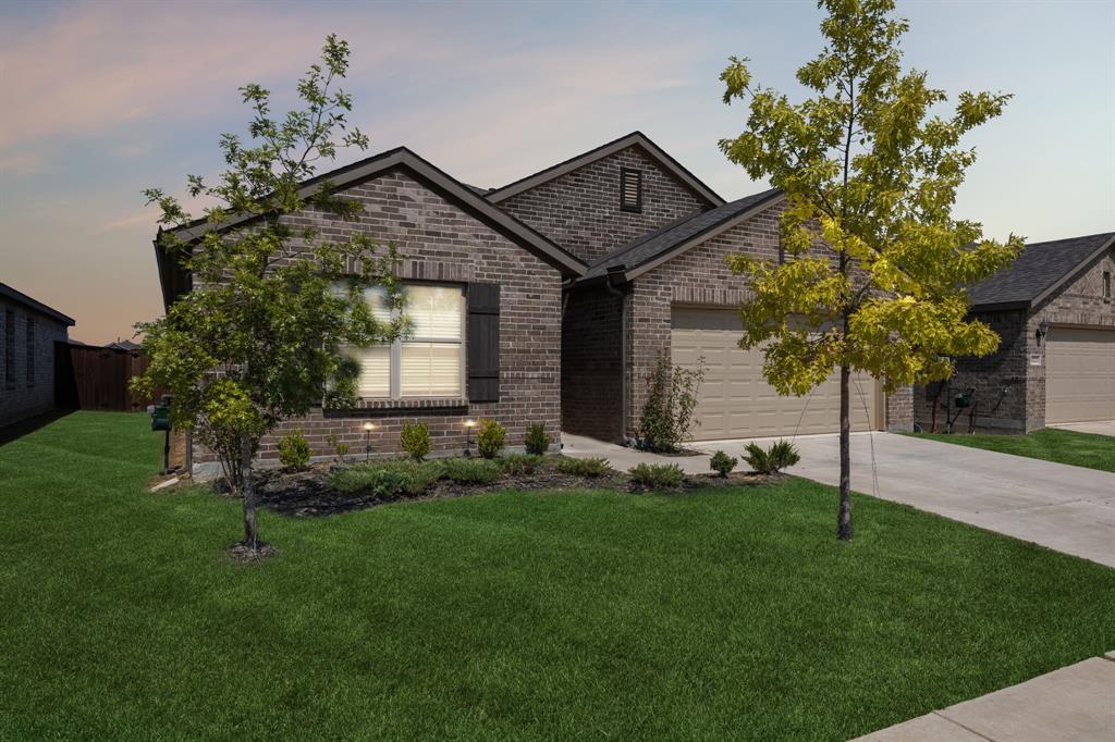 14219 Aberavon Drive Pilot Point, TX 76258 - Photo 2 of 25 a front view of a house with a yard and garage
