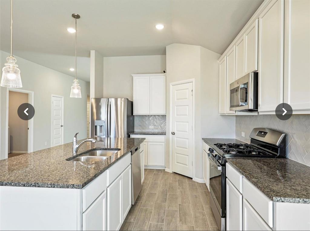 14219 Aberavon Drive Pilot Point, TX 76258 - Photo 4 of 25 a kitchen with stainless steel appliances granite countertop a sink stove and refrigerator