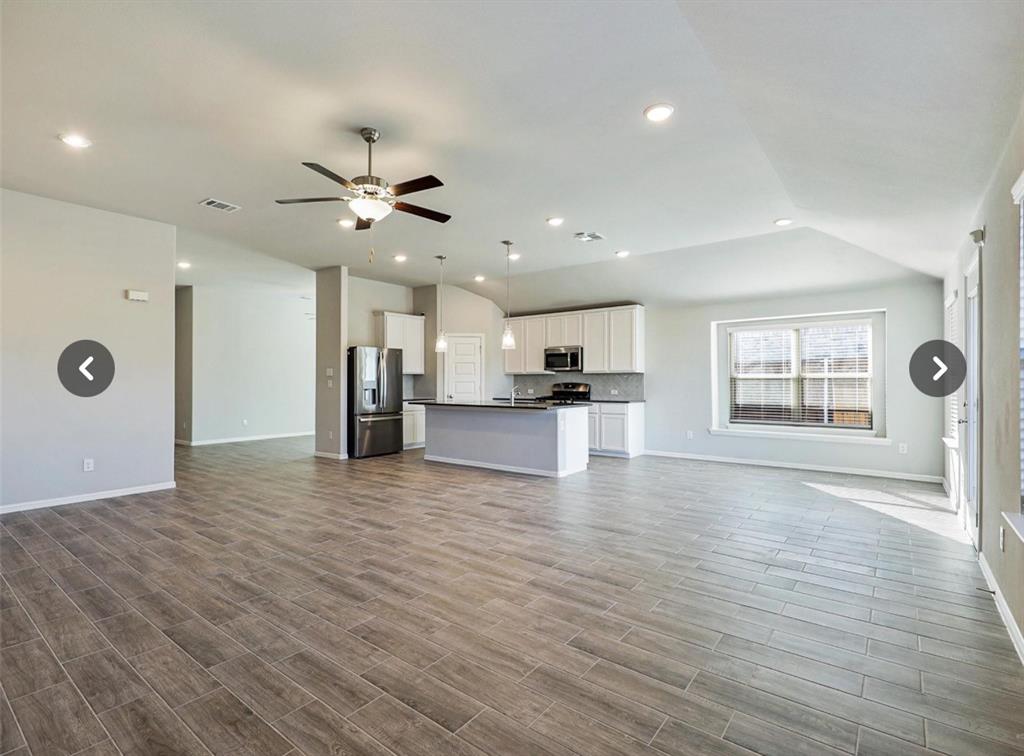 14219 Aberavon Drive Pilot Point, TX 76258 - Photo 5 of 25 a view of an empty room with a kitchen and a window