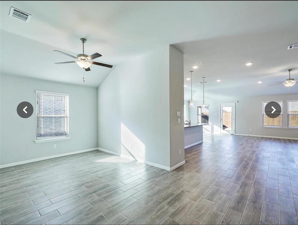 14219 Aberavon Drive Pilot Point, TX 76258 - Photo 7 of 25 a view of an empty room with a window and wooden floor