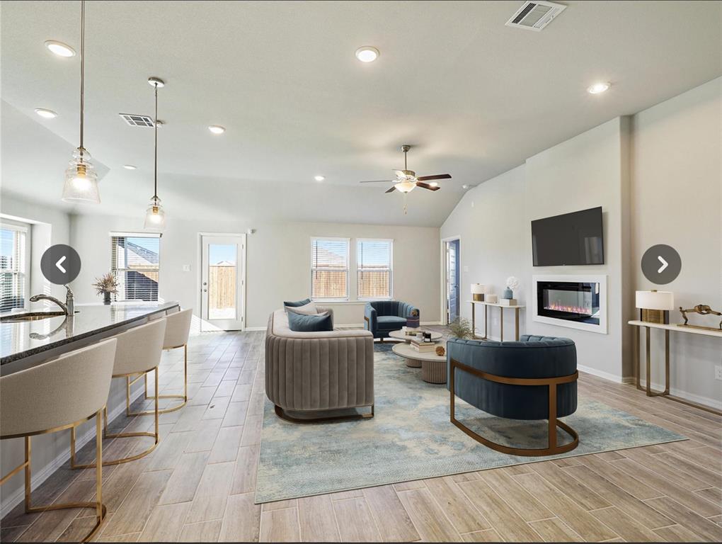 14219 Aberavon Drive Pilot Point, TX 76258 - Photo 8 of 25 a living room with furniture a flat screen tv and kitchen view