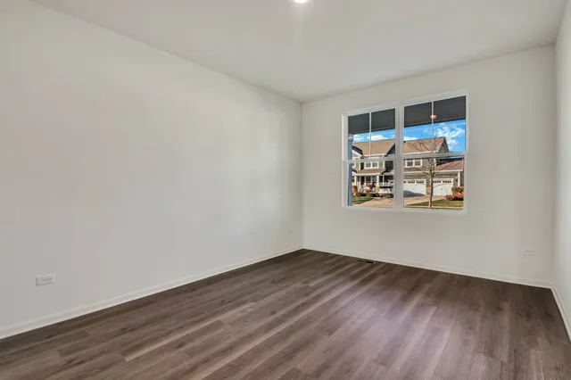 a room with wooden floor and white walls