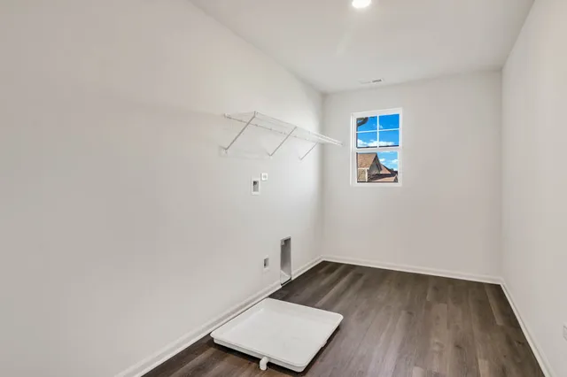 a view of a room with wooden floor and white walls