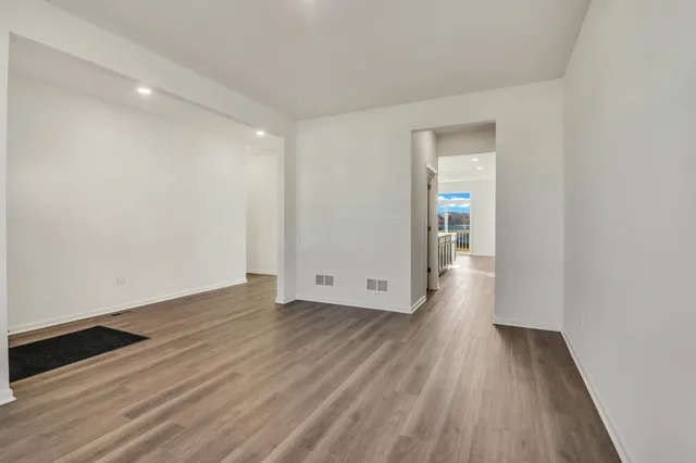 a view of a hallway with wooden floor