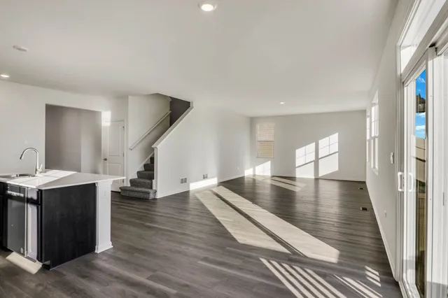 a view of a living room with hardwood floor and a ceiling fan