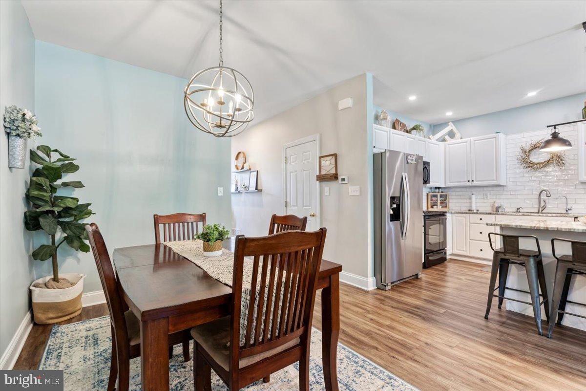 22 Sugar Maple Road Barto, PA 19504 - Photo 7 of 33 a view of a dining room with furniture a chandelier and wooden floor