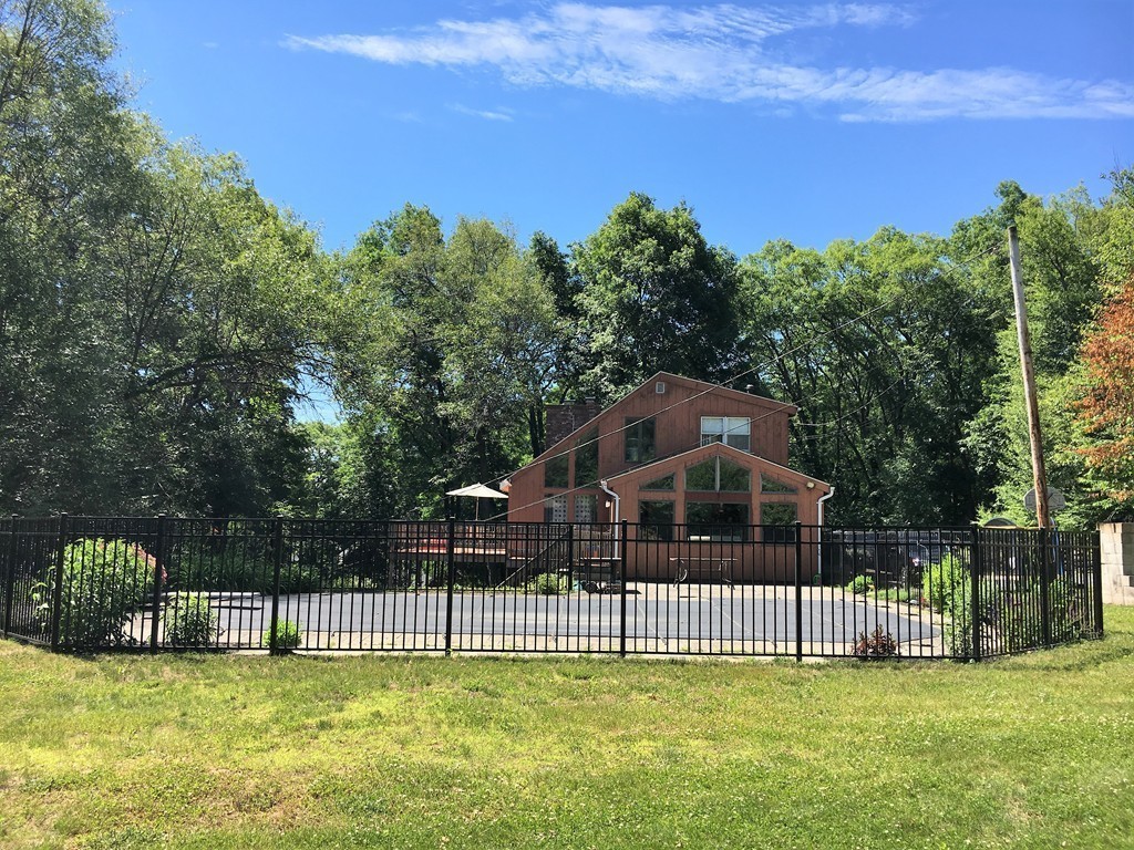 6 Dolan Road Millbury, MA 01527 - Photo 1 of 30 a view of a house with a big yard and large trees