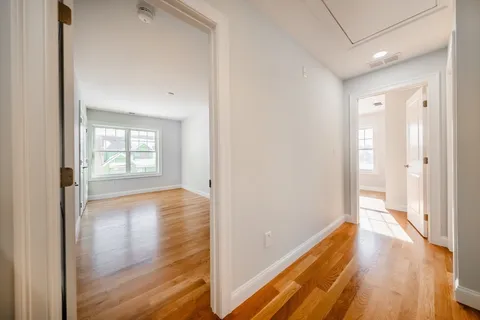 a view of hallway with wooden floor