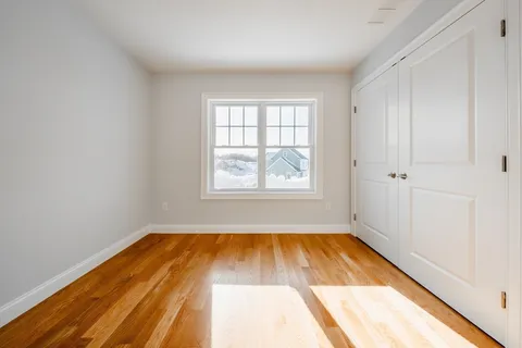 a view of a room with wooden floor and window