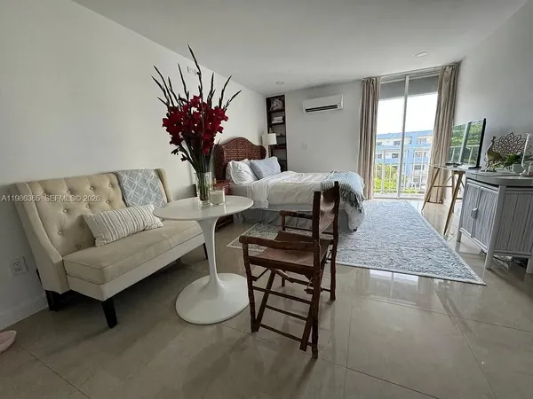 a living room with furniture and floor to ceiling window