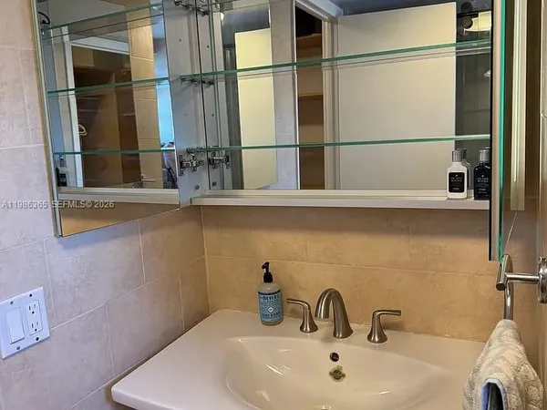 a bathroom with a sink and mirror