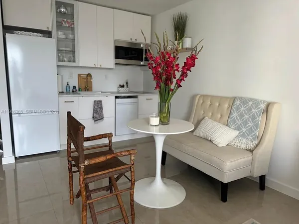 a view of kitchen with furniture and a potted plant