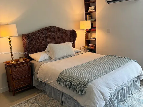 a bedroom with a bed and cabinets