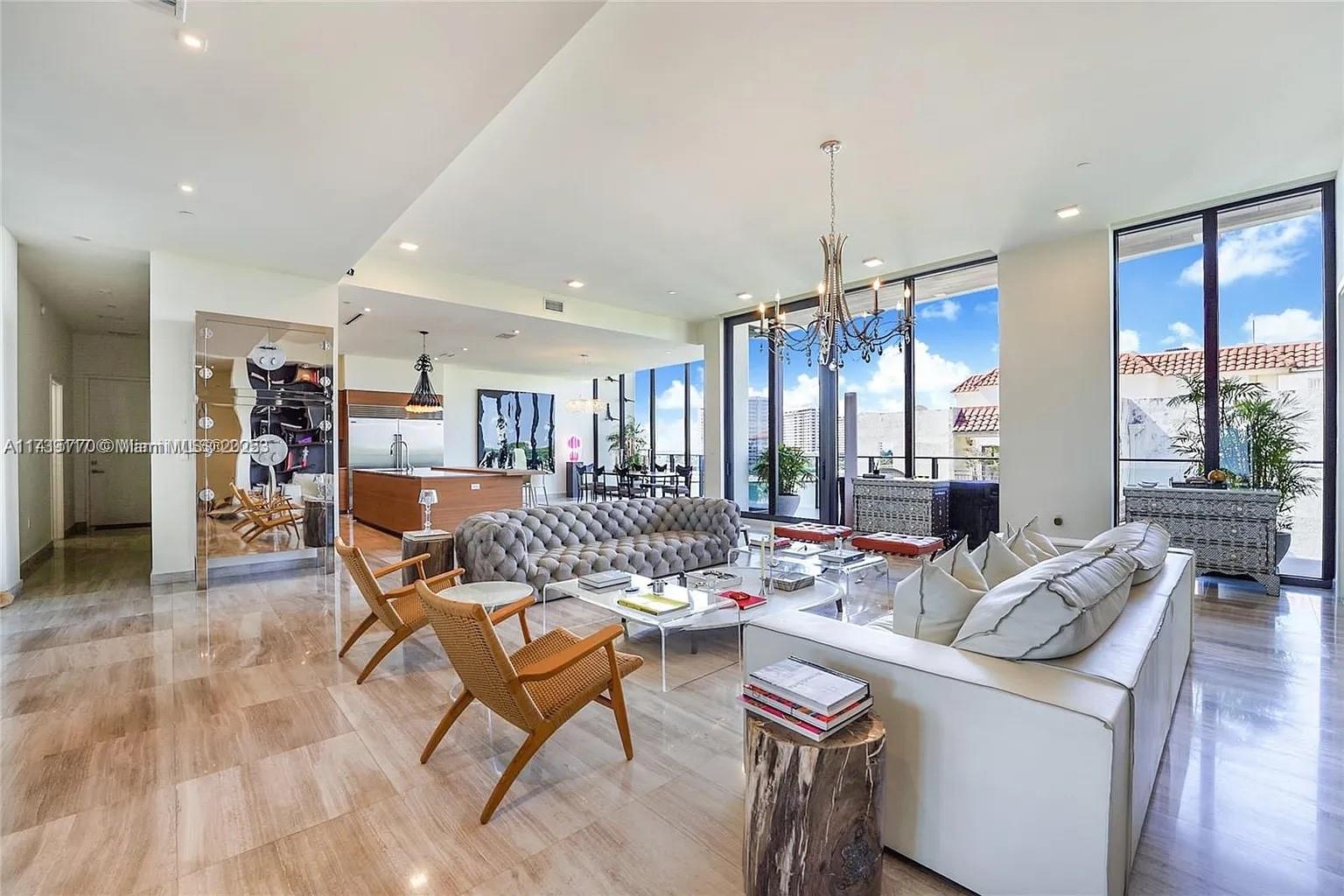 a living room with furniture and a chandelier