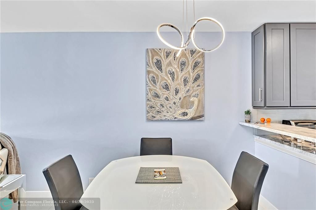 1439 South Ocean Boulevard, Unit 312 Lauderdale-by-the-Sea, FL 33062 - Photo 24 of 26 Custom built Italian glass table complete with an expansive leaf...perfect for entertaining.