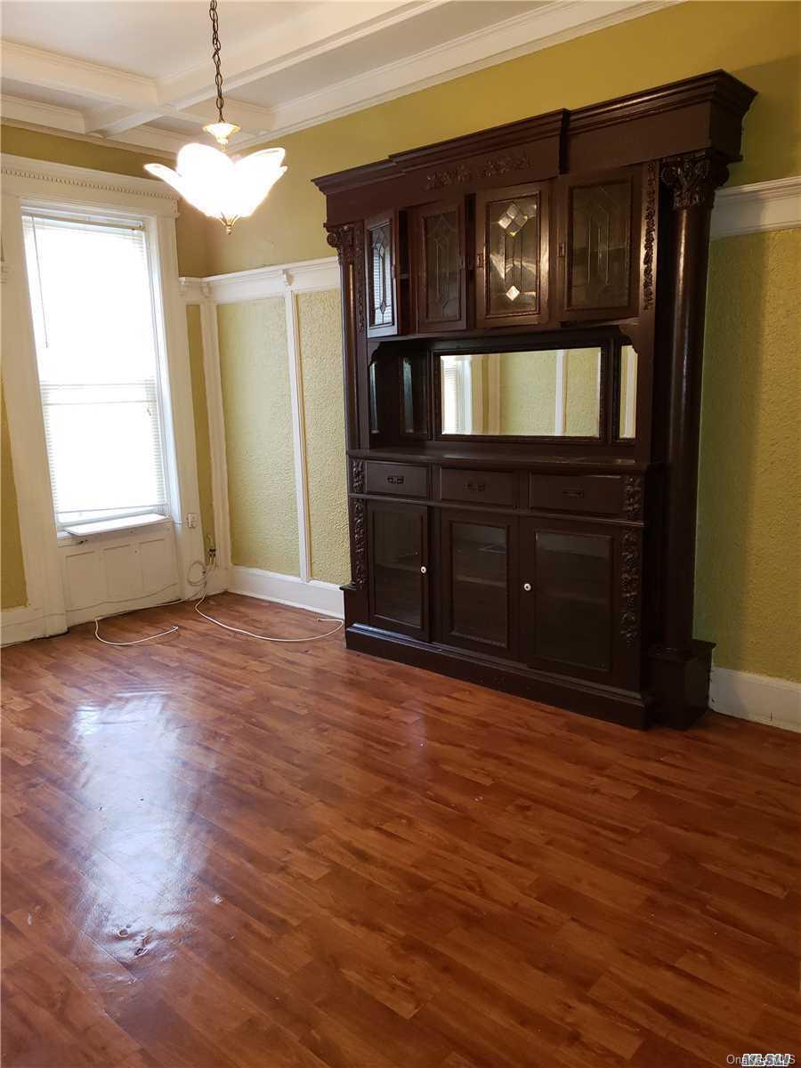 1425 Hancock Street Brooklyn, NY 11237 - Photo 11 of 20 a view of an empty room with wooden floor and a window