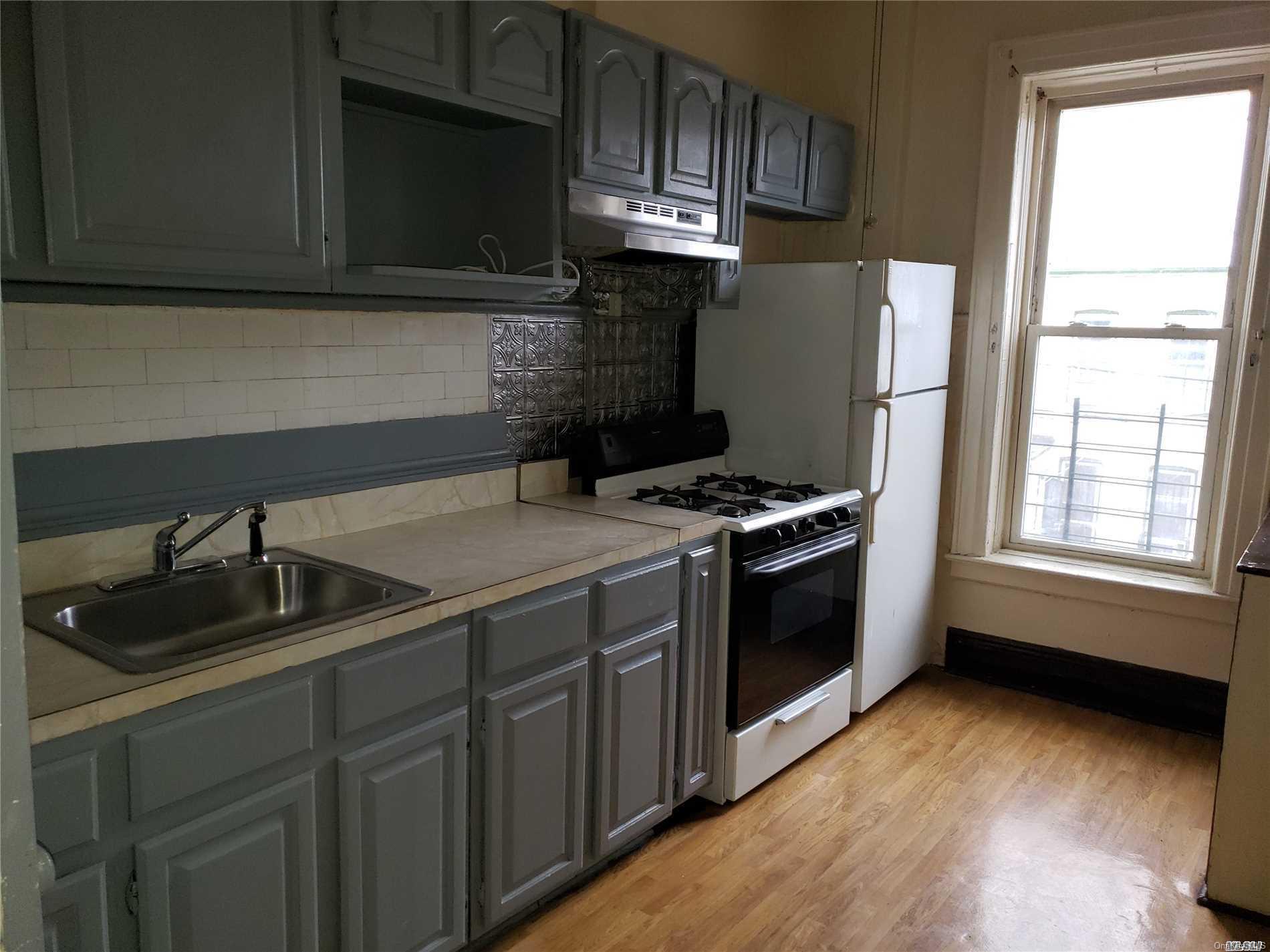 1425 Hancock Street Brooklyn, NY 11237 - Photo 15 of 20 a kitchen with a sink a stove and cabinets