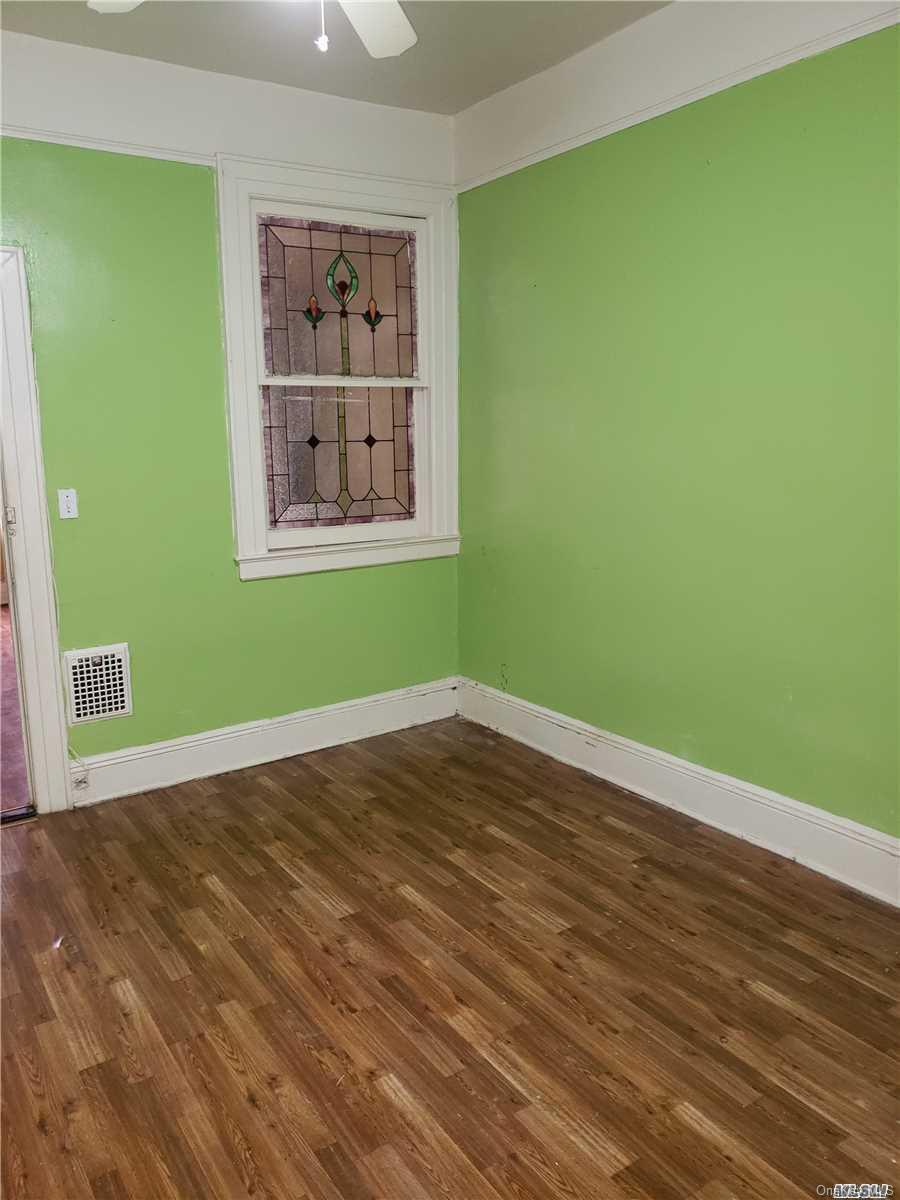1425 Hancock Street Brooklyn, NY 11237 - Photo 18 of 20 a view of an empty room with window and wooden floor