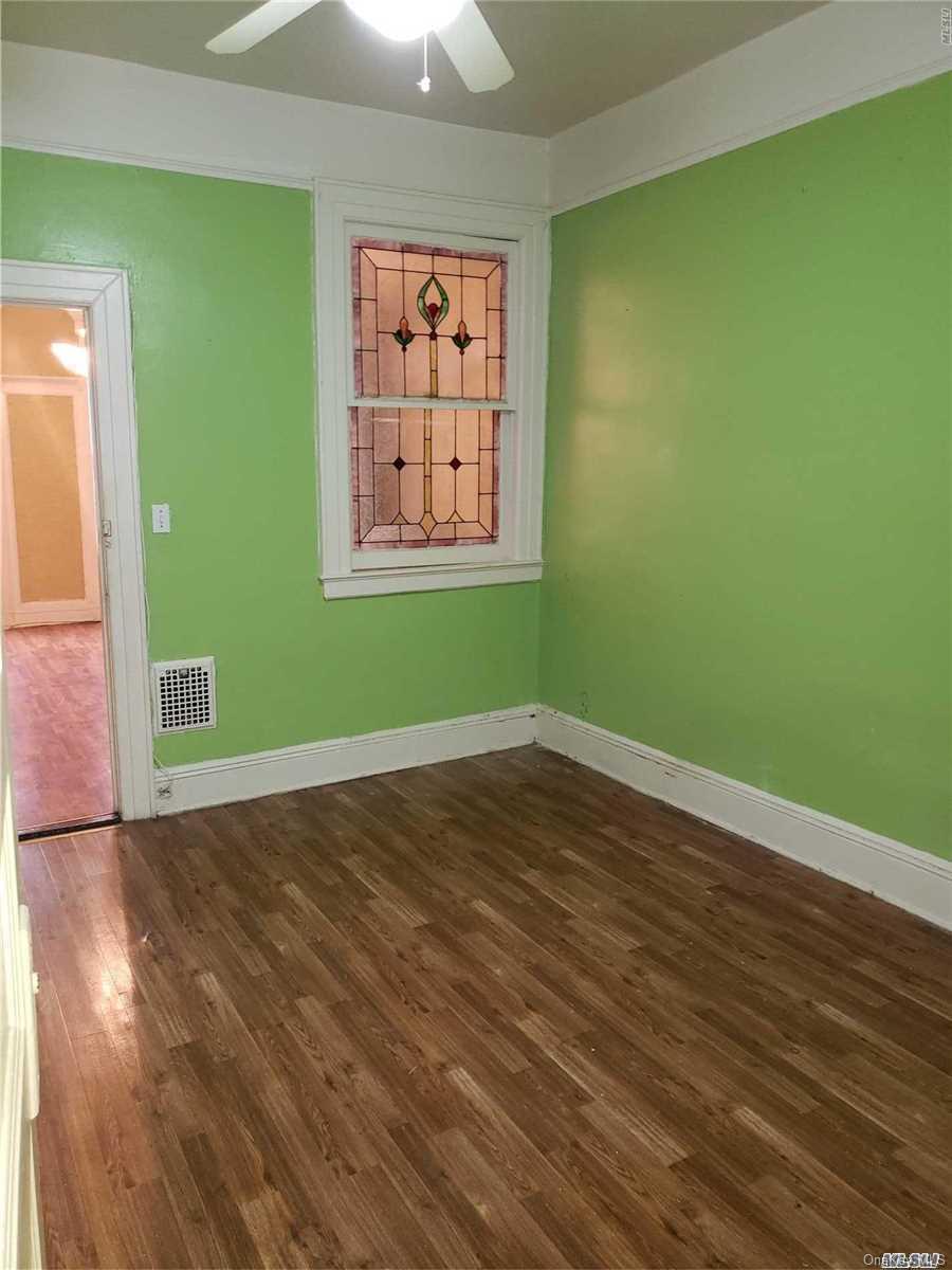 1425 Hancock Street Brooklyn, NY 11237 - Photo 20 of 20 an empty room with wooden floor and windows