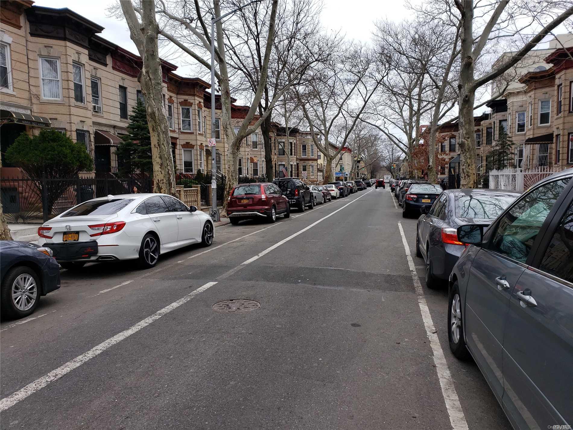 1425 Hancock Street Brooklyn, NY 11237 - Photo 4 of 20 a view of a city street with a couple of cars parked on the roadside