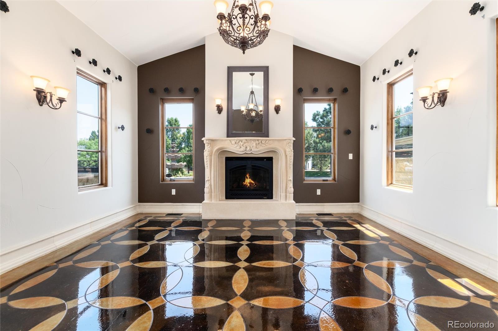 8417 High Ridge Court Castle Pines, CO 80108 - Photo 14 of 48 a living room with a fireplace windows and a fireplace