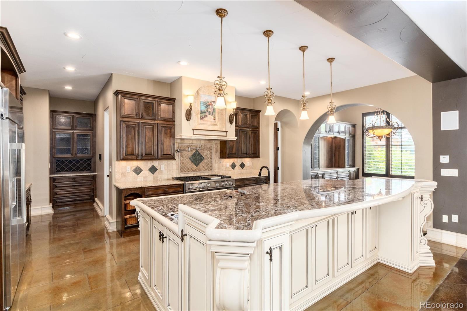 8417 High Ridge Court Castle Pines, CO 80108 - Photo 20 of 48 a kitchen with stainless steel appliances granite countertop a sink a stove and a wooden floors