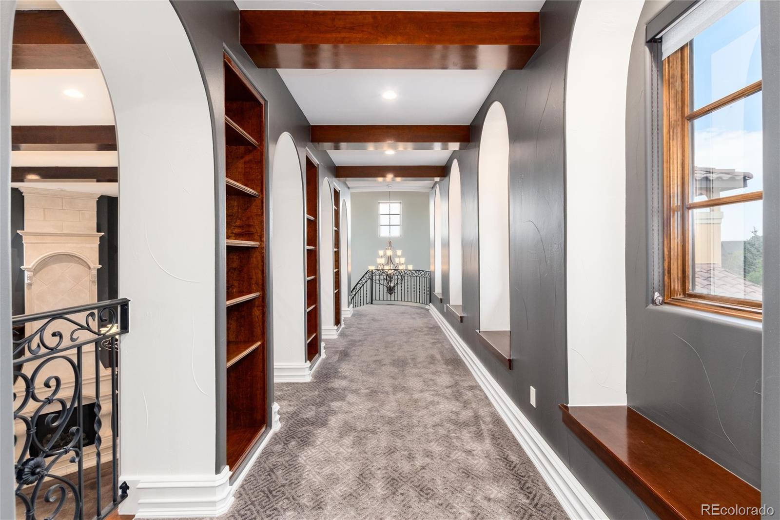 8417 High Ridge Court Castle Pines, CO 80108 - Photo 25 of 48 a view of a hallway with wooden floor and windows