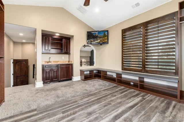 a bathroom with a granite countertop toilet a sink a mirror a bathtub and shower