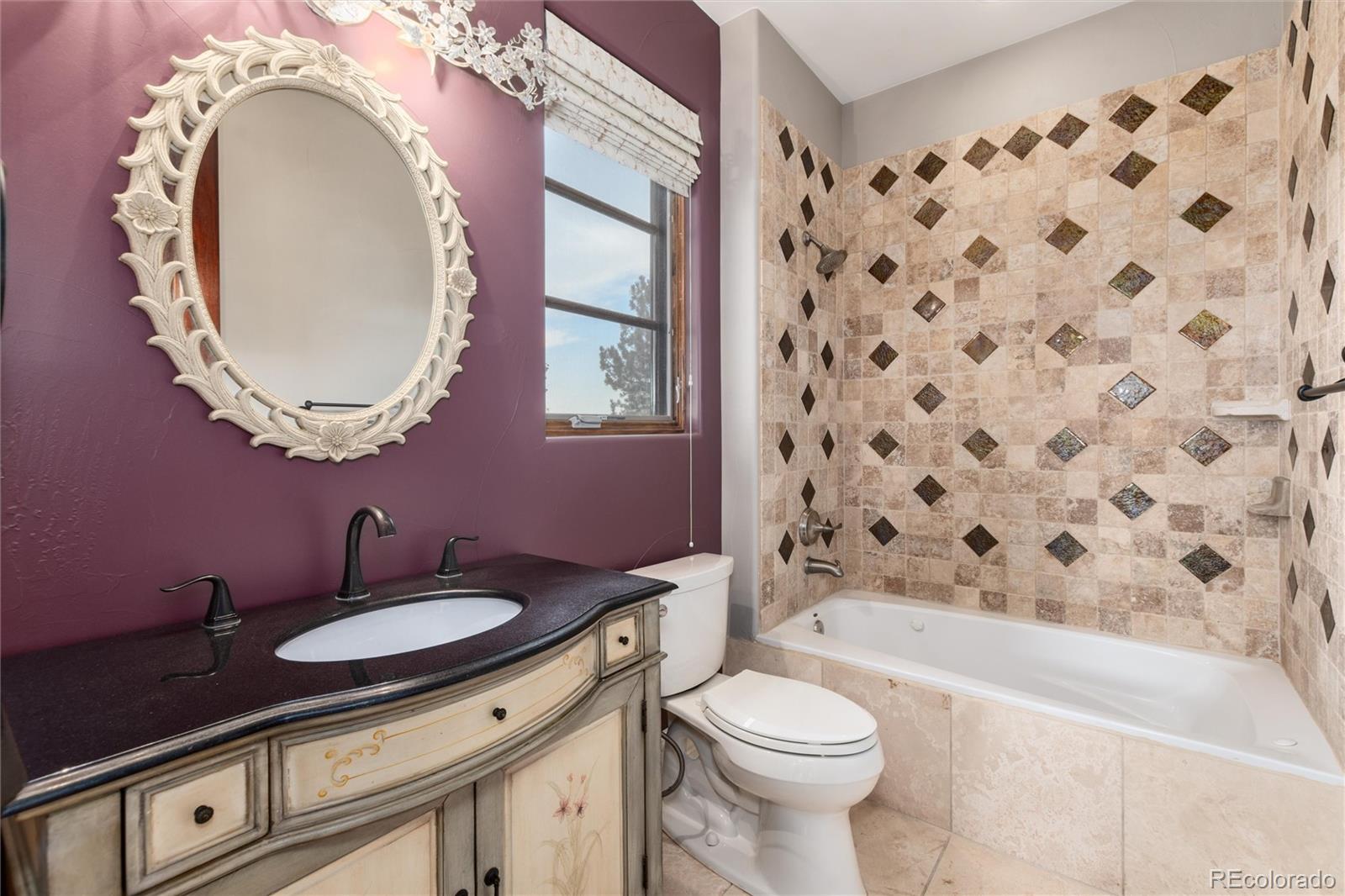 8417 High Ridge Court Castle Pines, CO 80108 - Photo 34 of 48 a bathroom with a granite countertop toilet a sink a mirror a bathtub and shower