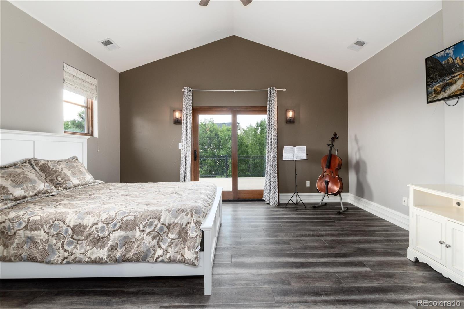 8417 High Ridge Court Castle Pines, CO 80108 - Photo 35 of 48 a bedroom with a bed and large windows