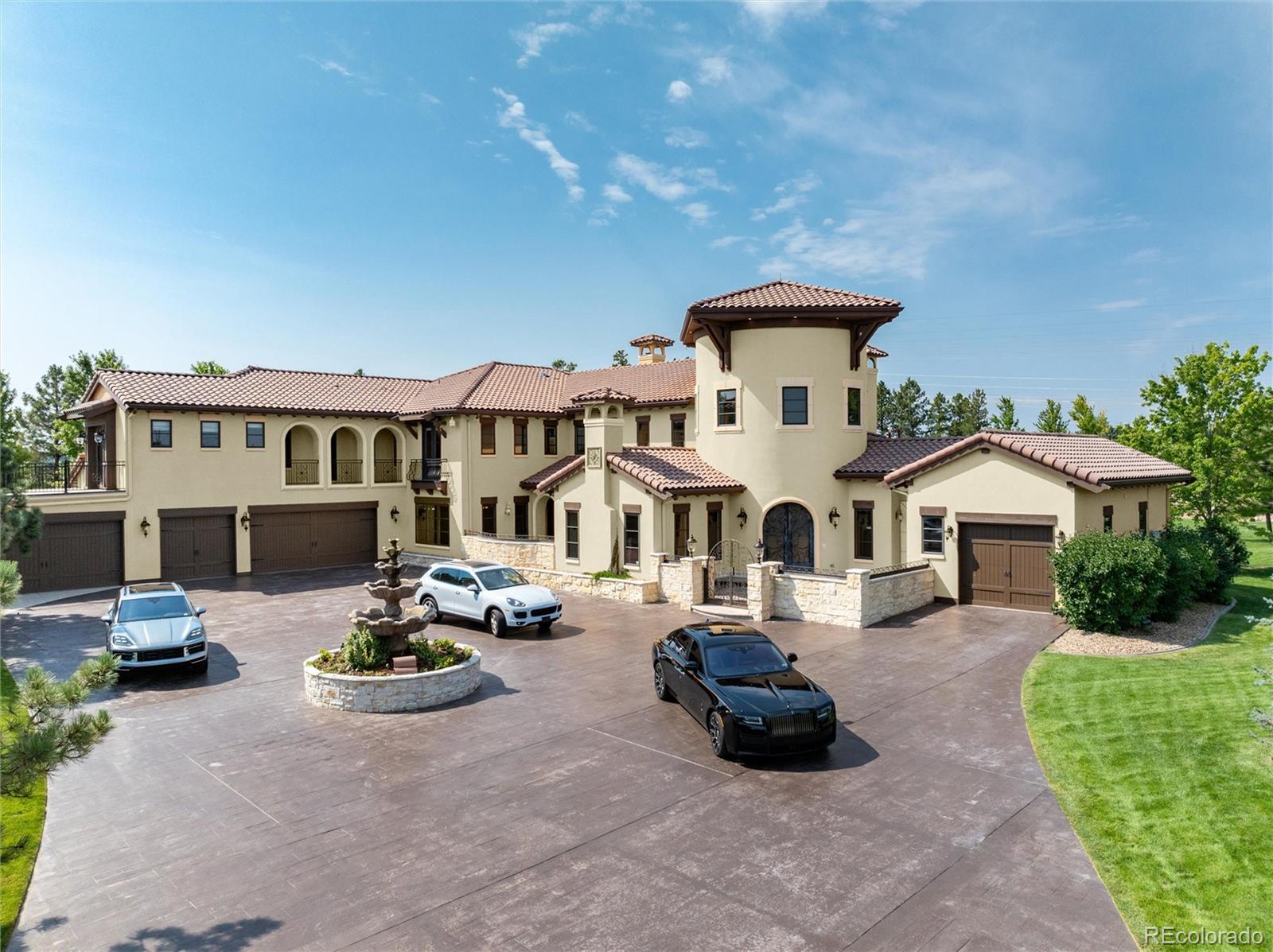 8417 High Ridge Court Castle Pines, CO 80108 - Photo 4 of 48 a front view of a house with a garden and mountain view