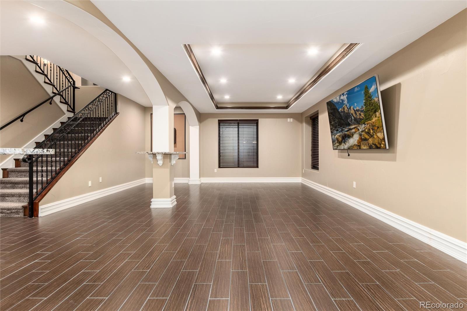 8417 High Ridge Court Castle Pines, CO 80108 - Photo 42 of 48 a view of an empty room with wooden floor
