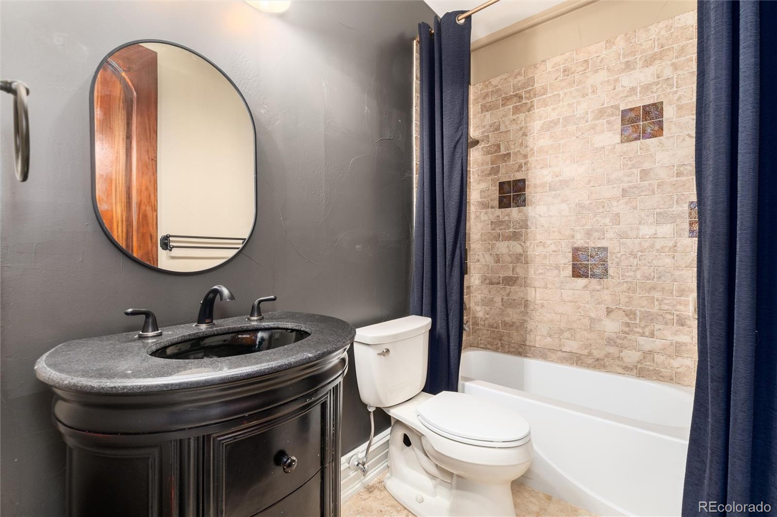 8417 High Ridge Court Castle Pines, CO 80108 - Photo 44 of 48 a bathroom with a sink a toilet and a mirror