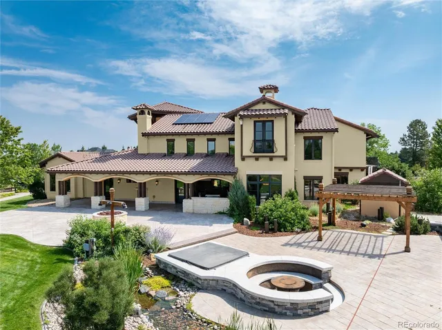 a view of a house with swimming pool and furniture