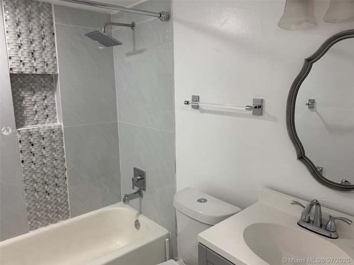 4176 Inverrary Drive, Unit 303 Lauderhill, FL 33319 - Photo 11 of 14 a bathroom with a sink a toilet and shower