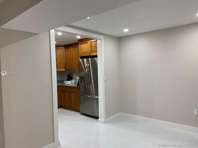 a view of a hallway and a livingroom with a chair