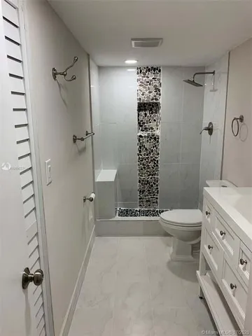 a bathroom with a sink toilet and shower