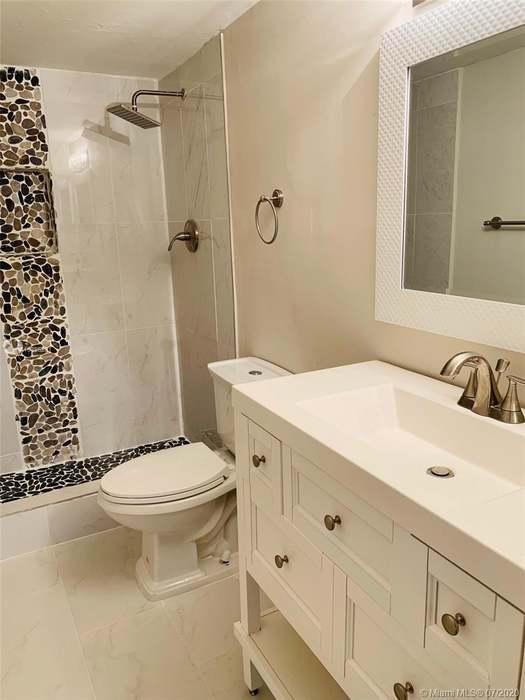 4176 Inverrary Drive, Unit 303 Lauderhill, FL 33319 - Photo 10 of 14 a bathroom with a sink toilet and shower