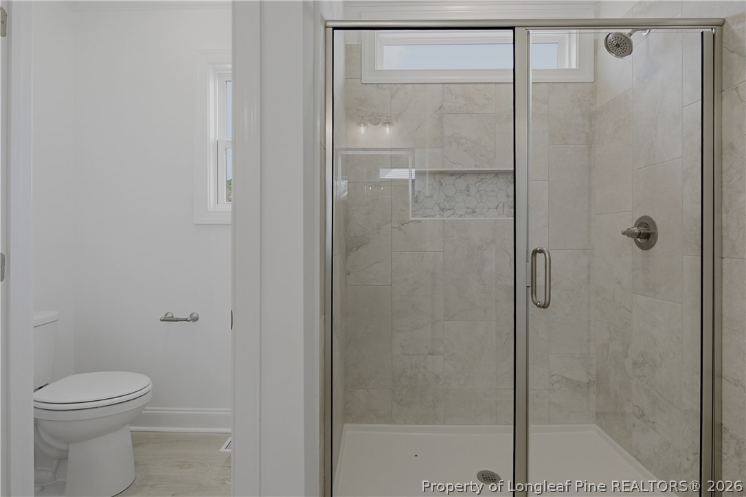 3187 Leaflet Church Road Broadway, NC 27505 - Photo 14 of 27 a bathroom with a toilet and a shower