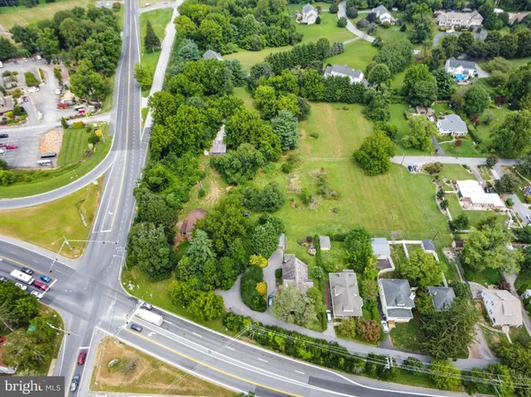 an aerial view of a house with a yard and lake view