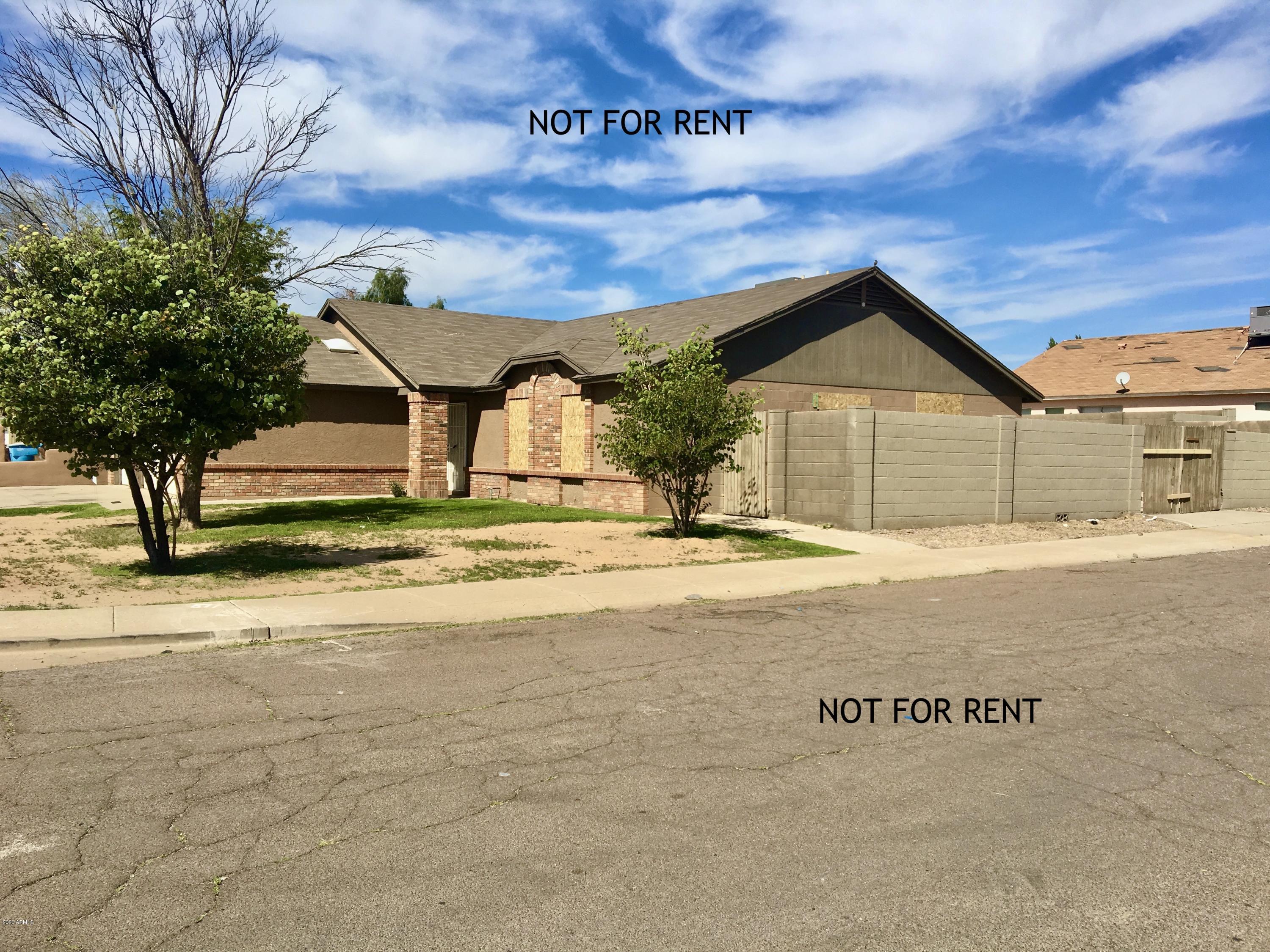 9006 West Granada Road Phoenix, AZ 85037 - Photo 2 of 2 a front view of a house with a yard