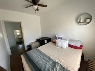 a bedroom with a bed window and a chair