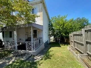 a view of house with backyard space and garden