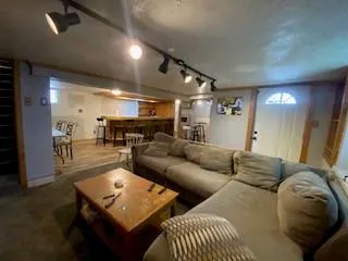 a dining hall with stainless steel appliances a dining table and chairs with wooden floor