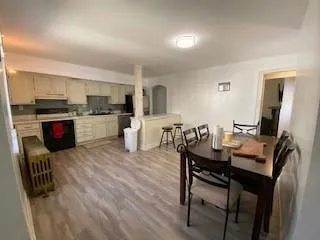 a large kitchen with kitchen island a large counter space a sink appliances and a window