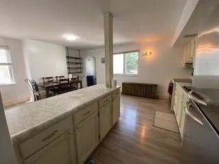a view of a livingroom with furniture and wooden floor