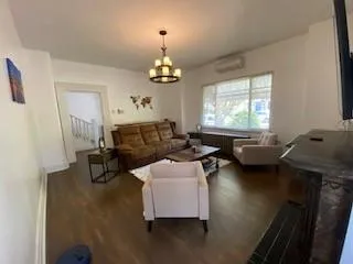 a view of a livingroom with furniture window and wooden floor